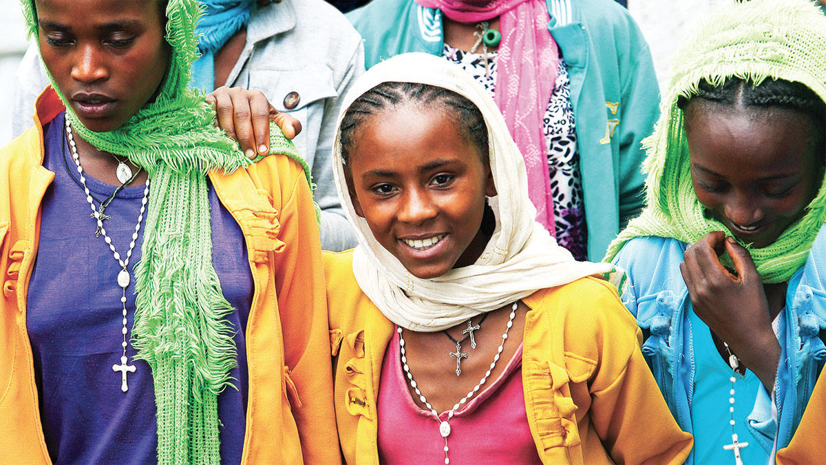 Smiling girls taking part in a procession