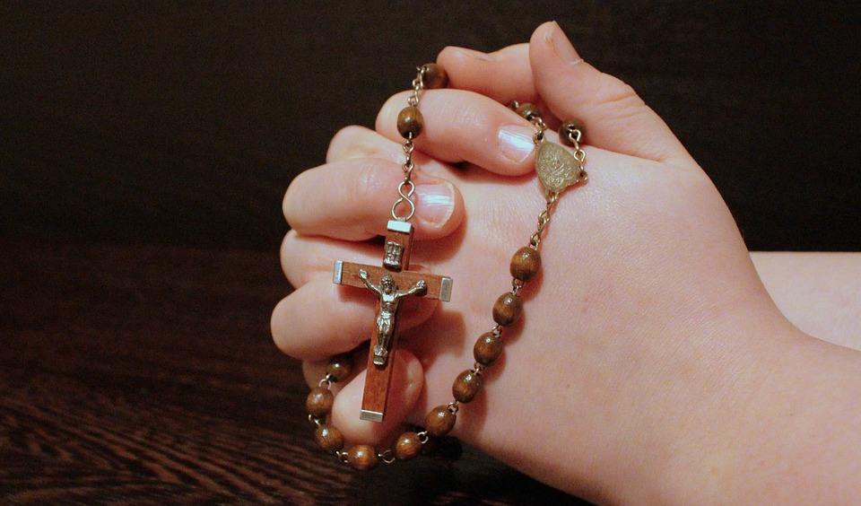 praying hands rosary beads
