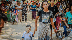 On their way to get food, a mother and her child at St Joseph's IDP camp in Mandalay, Myanmar