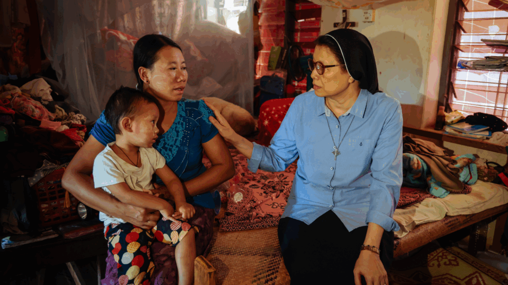 Missionary, Sister Regina, with Francisca and her child at an IDP camp in Myanmar