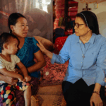 Missionary, Sister Regina, with Francisca and her child at an IDP camp in Myanmar