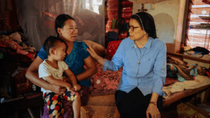 Missionary, Sister Regina, with Francisca and her child at an IDP camp in Myanmar