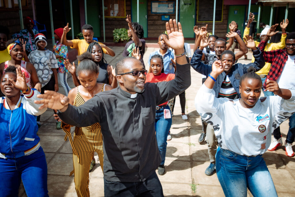 After Mass, Fr Patrick celebrates with young people attending an interfaith youth activity at a shelter for orphaned and former street children in Nairobi, Kenya