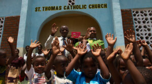 Fr Henry in Malawi with the Red Box at St Thomas' Catholic Church